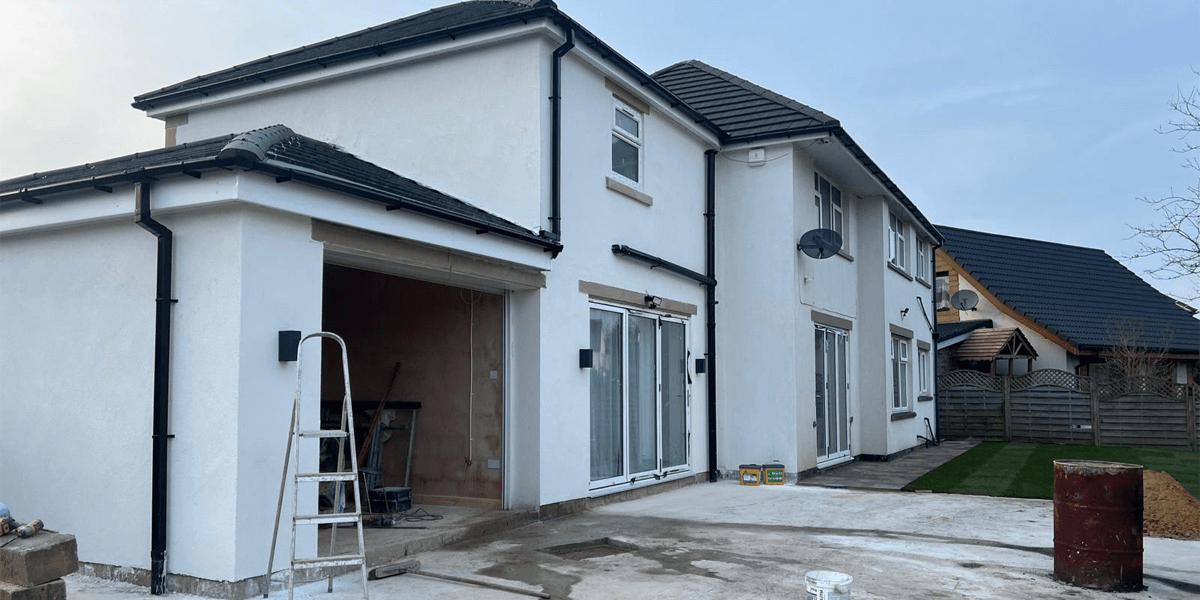 Residential home extension with garage, K-Rend exterior and landscaped garden completed by IQ Builders in Bradford